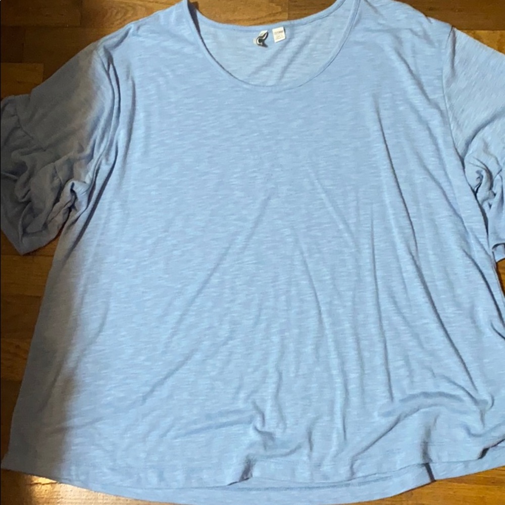 3️⃣ Woman’s baby blue shirt with ruffle sleeves